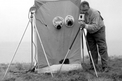 Eric Hosking adjusting electronic flash equipment by a bird hide - late 1950's